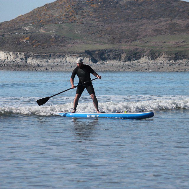 Joel testing out one of his new shark SUPs. #woolacombe #devon #sup #standuppaddle. Photo by: @essexrambler