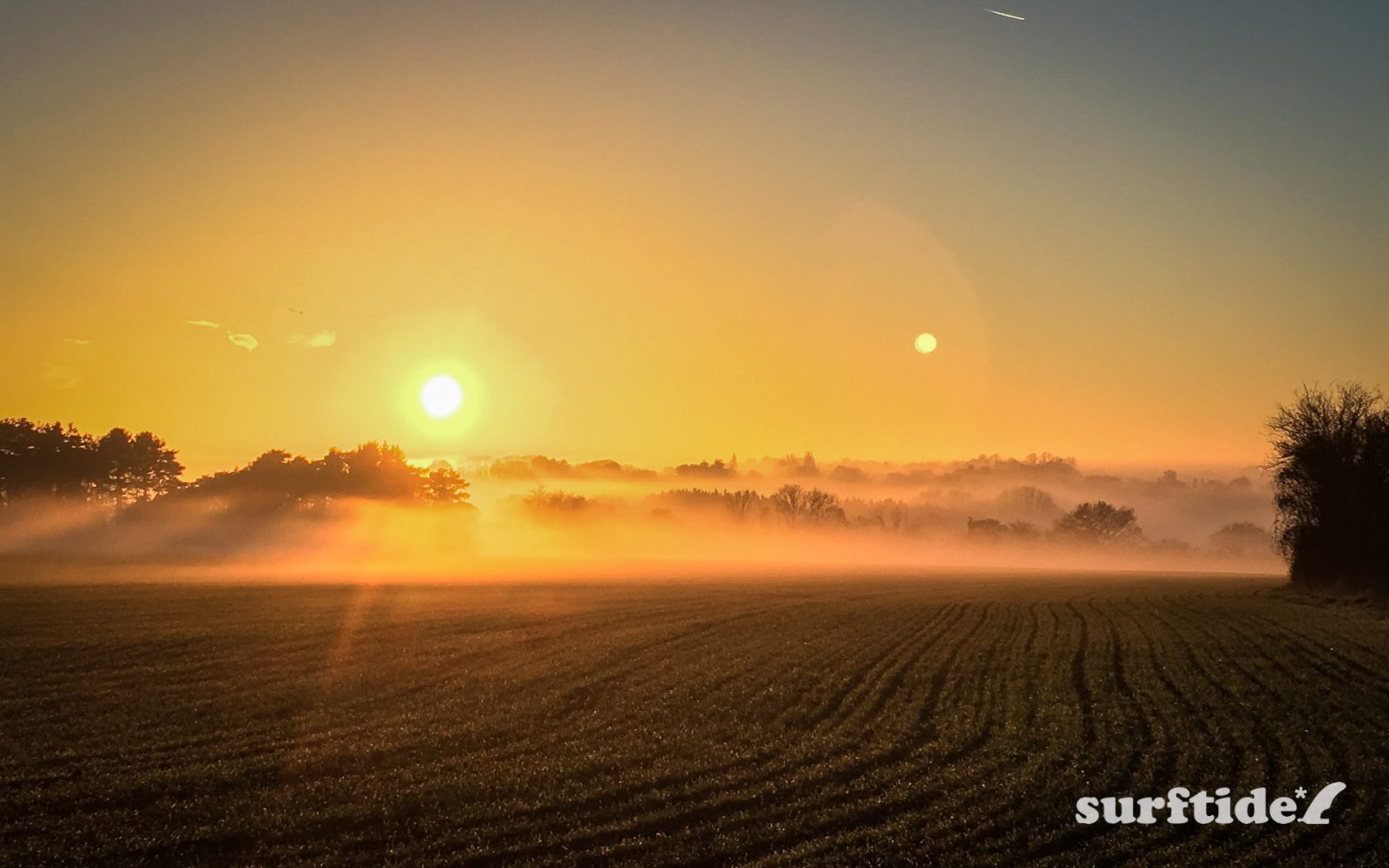 Misty winter sunset across a farmer's field in Bishops Stortford, Hertfordshire