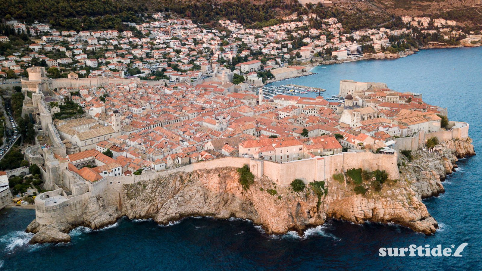 Aerial view of the city of Dubrovnik showing the historic city walls and the sea and harbour