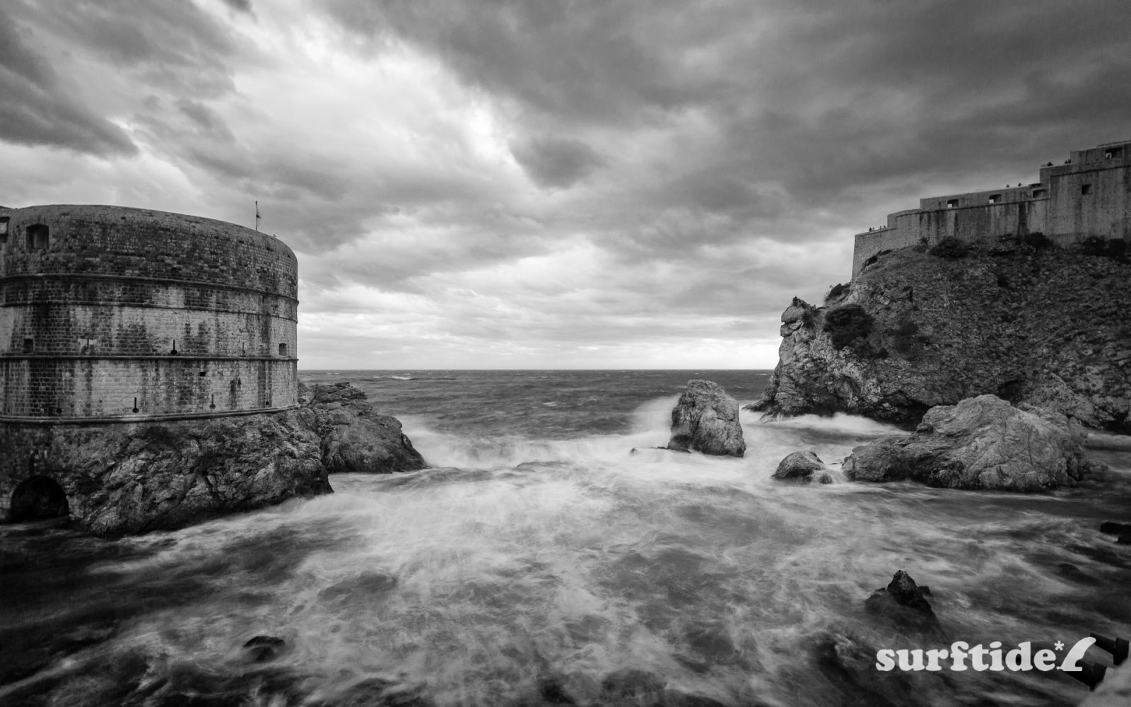 Black & white photo of storm waves entering Dubrovnik West harbour in southern Croatia