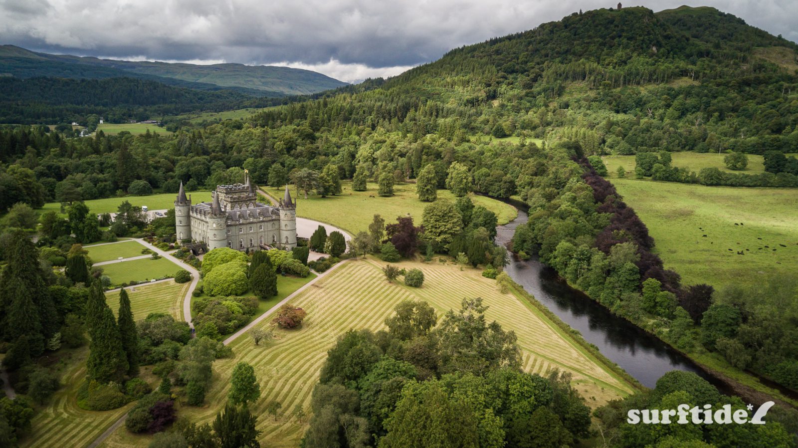 Aerial view of the river, grounds and surrounding hills on a cloudy day at Inveraray Castle in Scotland