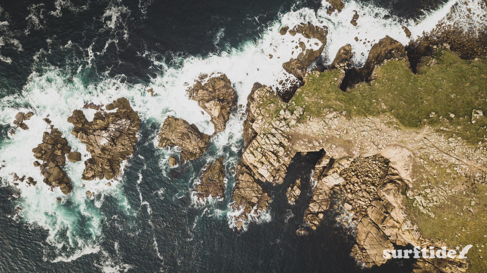Aerial photo showing top-down view of Lands End headland, Cornwall, England