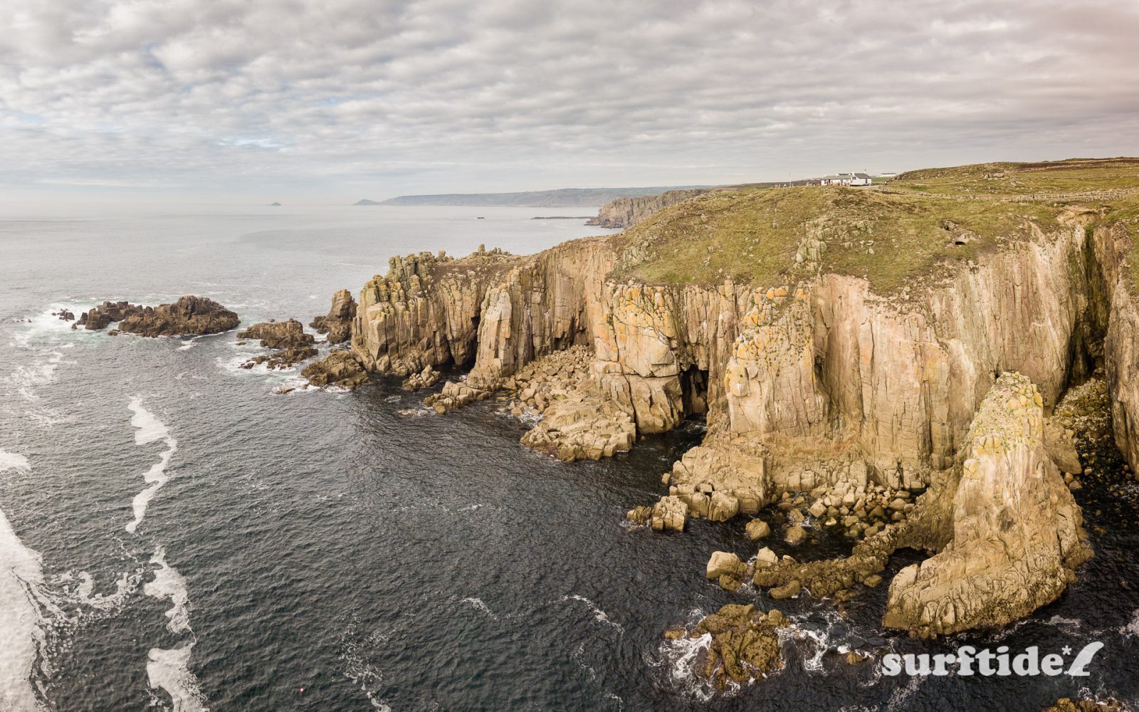 Aerial photo of the sea and rocky coastline at Land's End, Cornwall, England