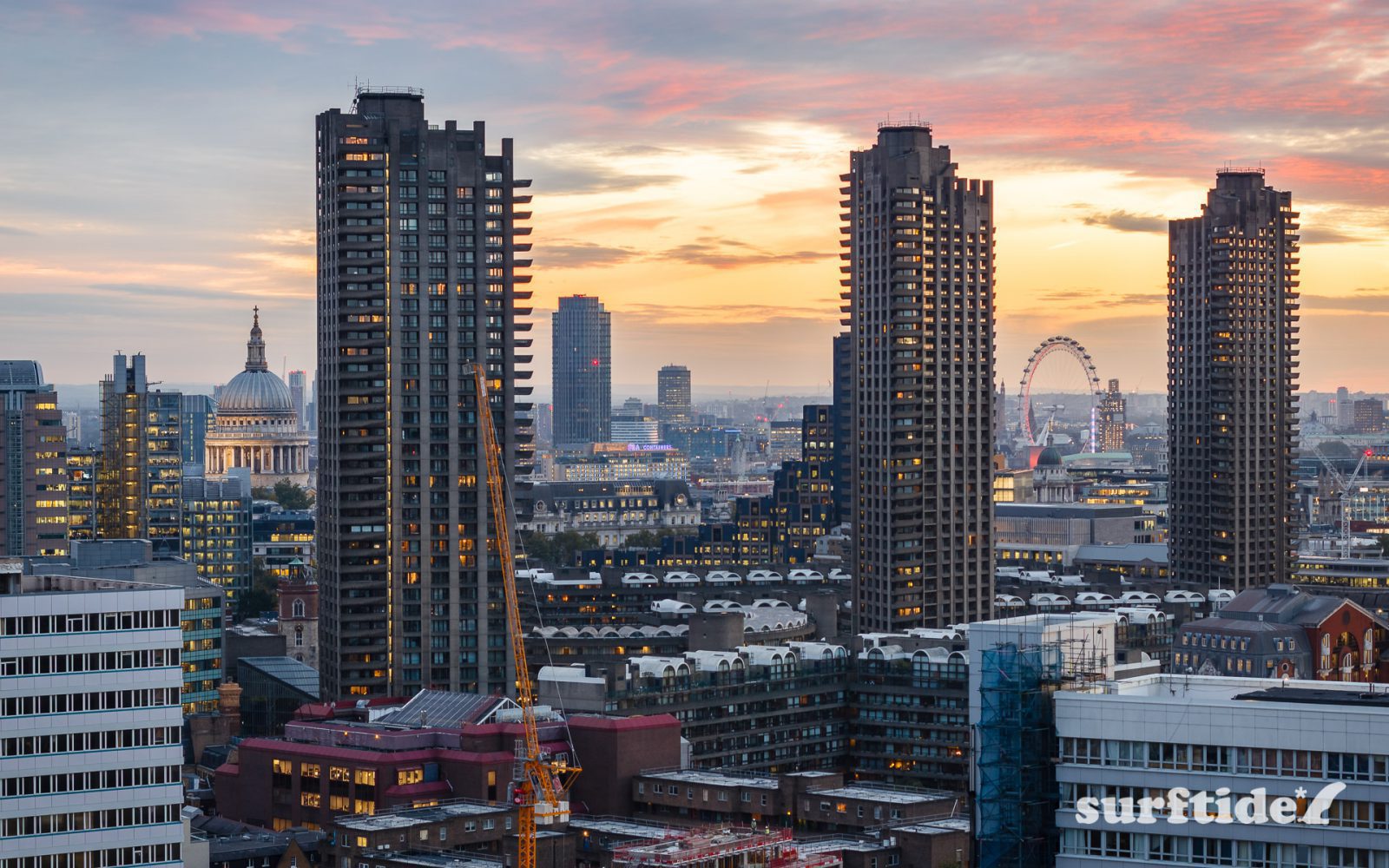 High dynamic range photo of the Barbican Towers at sunset with the London skyline as a backdrop