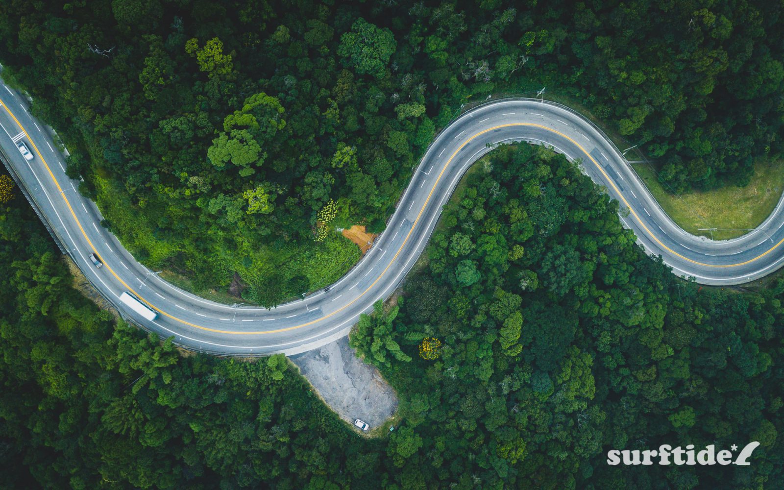 Aerial shot of winding road through tropical mountains in Brazil